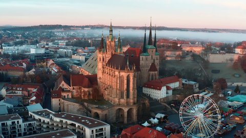 Aerial Panning Shot Of St. Severus Church Amidst Houses In Old Town During Foggy Weather - Erfurt, Germany