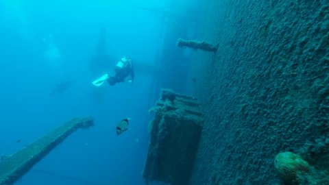 Scuba diver swims near shipwreck Swedish ferry MS Zenobia. Wreck diving. Mediterranean sea, Cyprus