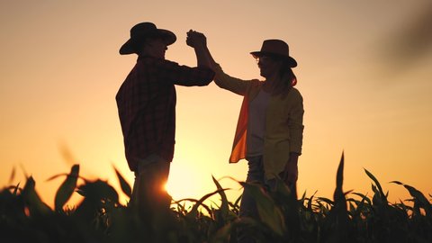 Agriculture. two farmers shake hands, conclude a business sunlight contract for a corn field. agriculture sale harvest concept. business handshake of farmers in a corn field. shake hands agriculture