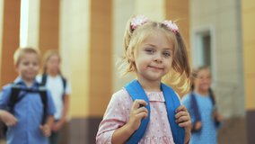 Happy girl back to school. Child goes to school with backpack. Girl with backpack walk through schoolyard. Happy family concept. Back to school. Girl walk to school with blue backpack in schoolyard - Powered by Shutterstock - Get 15% off with code: PIKWIZARD15