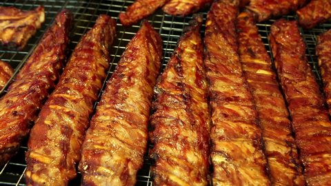 grilled barbecue bbq pork ribs in a street food market stall in phuket, thailand.