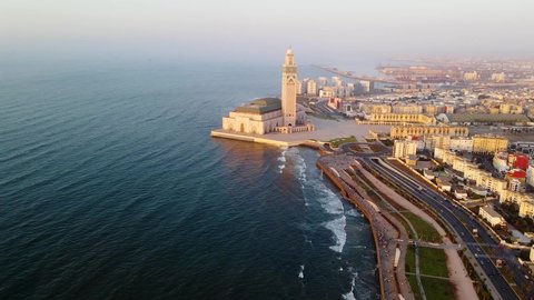 Aerial view around the Hassan II mosque, sunrise in Casablanca, Morocco - circling, drone shot