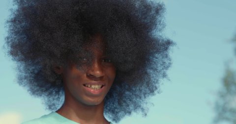 African American adolescent boy with huge Afro looking into the camera