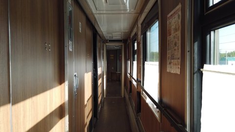 Interior of a passenger train, inside a compartment carriage, corridor.