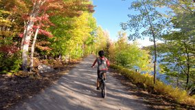 Autumn Mountain biking in fall. Mountain biker riding MTB bicycle on forest gravel trail in fall foliage with colorful leaves. Woman living healthy sports lifestyle in the Laurentians, Quebec, Canada - Powered by Shutterstock - Get 15% off with code: PIKWIZARD15