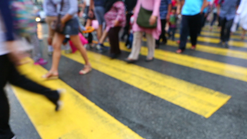 People crossing the street in a crosswalk during rush hour in Bukit Bintang, Kuala Lumpur, Malaysia. Royalty-Free Stock Footage #1077924812