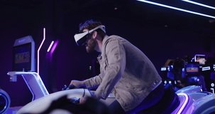 A man with a beard in virtual reality glasses controls a motorcycle. New features of virtual reality. Virtual games. The concept of virtual driving instruction.