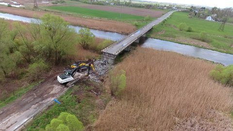 Aerial video of destroyed bridge. Broken road across river. View an old highway over the clear shallow water. Aerial view of broken bridge on the waters