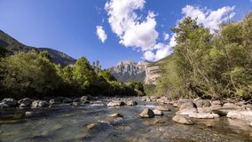 Timelapse video of a wild river and the mountains in the monte pedido natural park in aragon spain