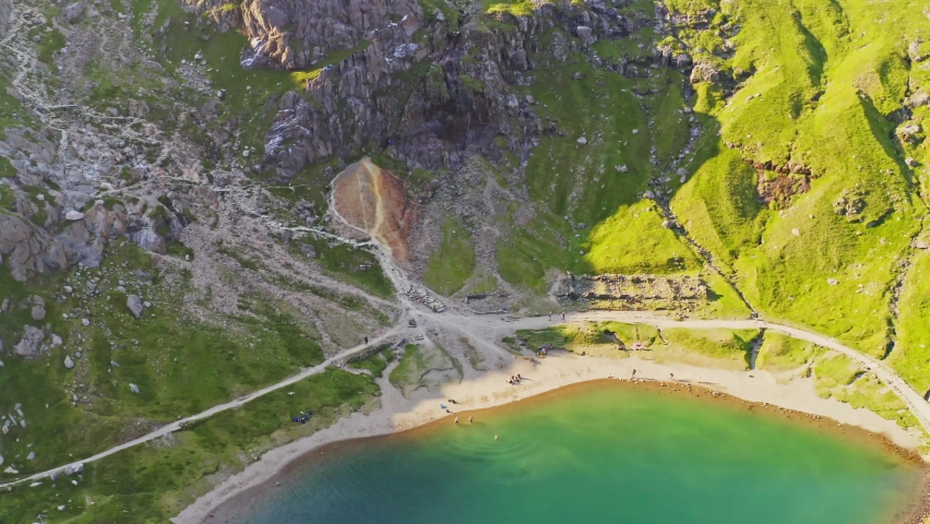 Snowdonia national park - slow descending aerial over the emerald waters of lake Llyn Llydaw. A popular tourist destination along the parks many trails. 