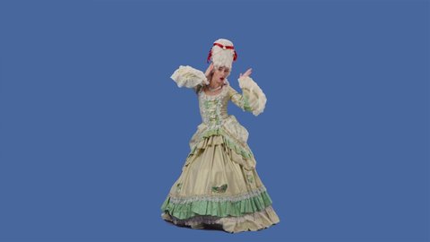 Portrait of courtier lady in white long vintage lace dress and wig is dancing merrily. Young woman posing in studio with blue screen background. Full lenght. Slow motion.