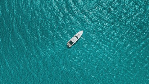 Turquoise blue water sea with yacht sail, aerial drone top view. One ship boat in beautiful nature ocean landscape. Summer holiday vacation voyage in Ayia Napa, Cyprus. Travel destination, tourism.
