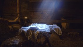 Nativity scene illuminated manger covered with white sheet located in dark inn stable on day of Jesus Christ birth in Bethlehem - Powered by Shutterstock - Get 15% off with code: PIKWIZARD15