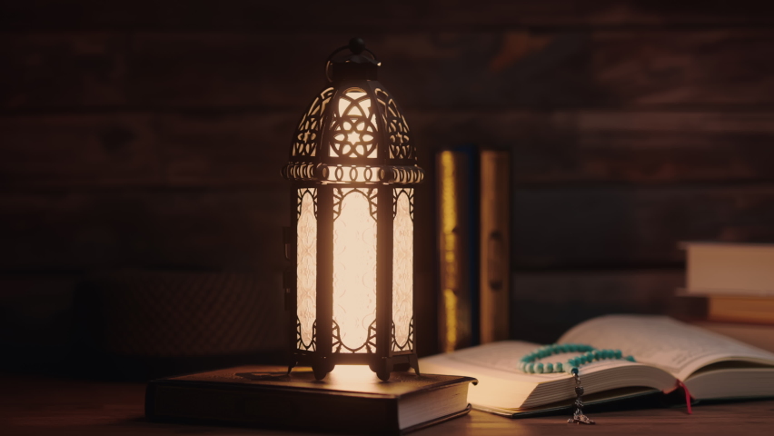 Islamic concept - The Holy Al Quran with written Arabic calligraphy meaning of Al Quran and a beautiful Arabian lamp, Arabic word translation : The Holy Al Quran (holy book of Muslim)