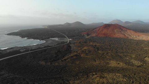 vulcanic valley with mountains in the background on a sunny day in Lanzarote Aerial Drone Footage 4K