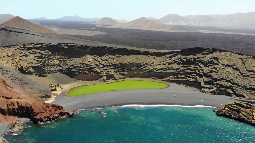 Lanzarote Island. Aerial view of Volcanic Lake and beach in El Golfo, Lanzarote, Canary Islands, Spain | Shutterstock HD Video #1077981377