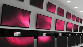 Interior of electronics store with synchronized video playing on screens of multiple televisions. electronics and retail business technology concept