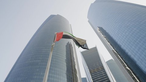 waving flag against the background of tall houses. abu dhabi etihad towers 08.08.2020 UAE