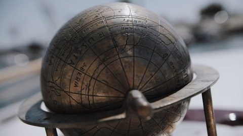 metal old earth globe and compass, the metal globe is spinning