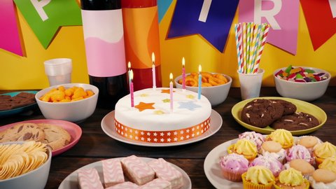 Lit Birthday Candles Cake On Table With Party Food