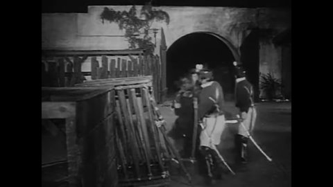 CIRCA 1936 - In this adventure movie, soldiers think they have caught Zorro but it is actually their bound and gagged commandante wearing a mask.