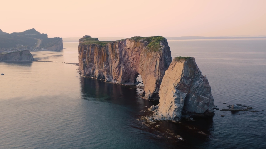 Aerial view of the Rocher Percé in the city of Percé in Quebec, Canada, at sunset, from drone