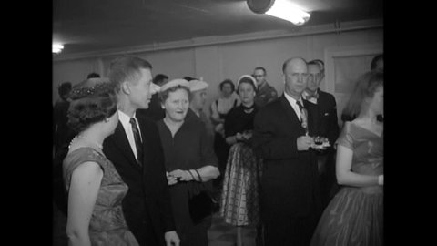 CIRCA 1955 - Civilians and servicemen stationed in Upper Marlboro, Maryland attend the reception of a soldier and a local girl.