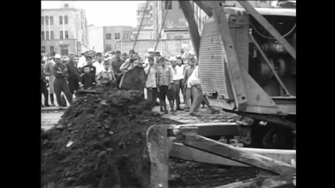 CIRCA 1950s - American military divisions use bulldozers to clean the debris in Japanese cities while the crowd watches in the 1950s.