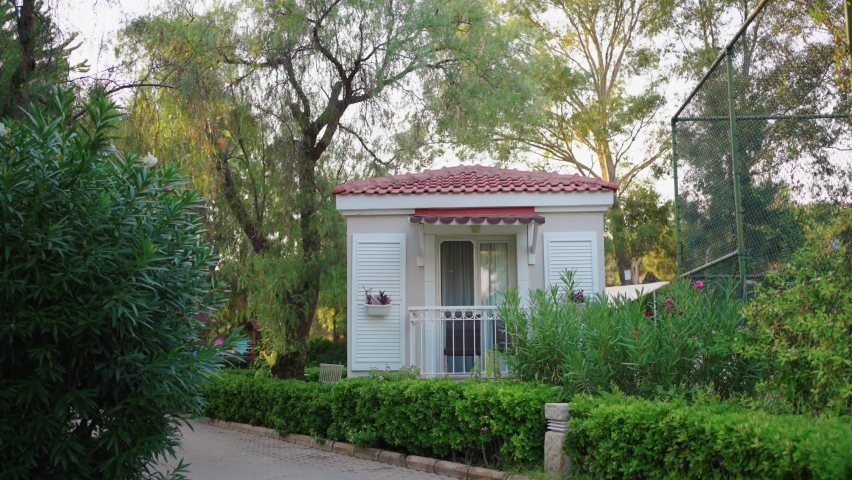 cute white house among greenery