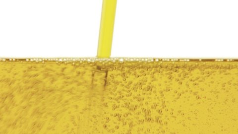 Olive oil filling a jug. Detail shot of the healthy yellow liquid, isolated on a white background, fast movement.

