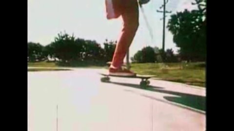 CIRCA 1970s - Skateboarders ride in an empty pool in 1976.