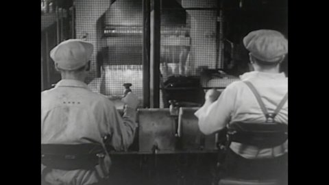 CIRCA 1950s - Men work to convert ore into steel in 1950.