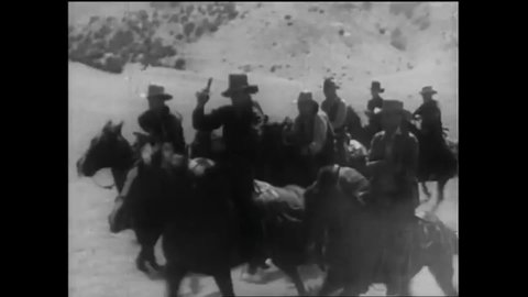 CIRCA 1936 - In this western film, a cowboy beats up a bandit on horseback and rescues his girlfriend from a stampede of wild horses.