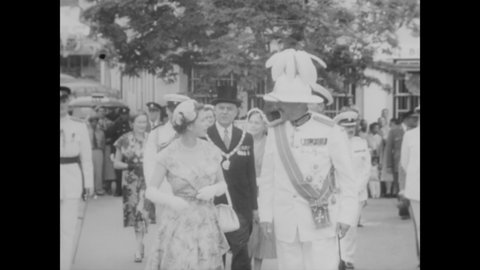 CIRCA 1953 - Bermuda's governor, Sir Alexander Hood, tours Queen Elizabeth II and Prince Philip around the island where they are cheered.