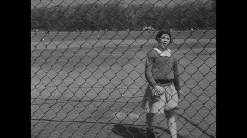 CIRCA 1931 - A young girl carries her baseball team to victory with her pitching and hitting.