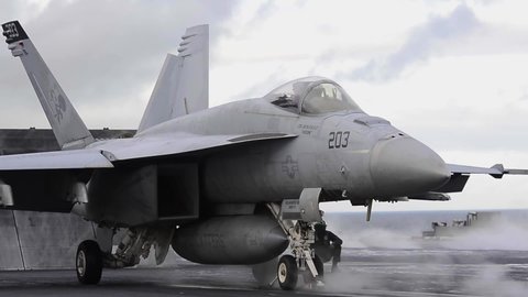 CIRCA 2021 U.S. Navy sailors conduct jet fighter plane operations on the aircraft carrier USS Theodore Roosevelt flight deck.