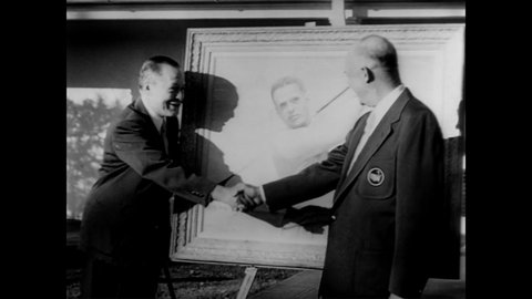 CIRCA 1953 - President Eisenhower presents a portrait he did of golfer Bobby Jones to the athlete himself.