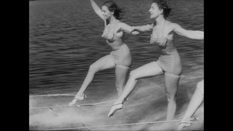 CIRCA 1952 - Women partake in synchronized waterskiing.