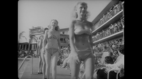CIRCA 1949 - People dive athletically and comically into a swimming pool, and women model different styles of bikinis poolside.