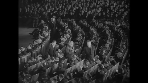 CIRCA 1951 - Men applaud the arriving speakers at a communist conference in Czechoslovakia.