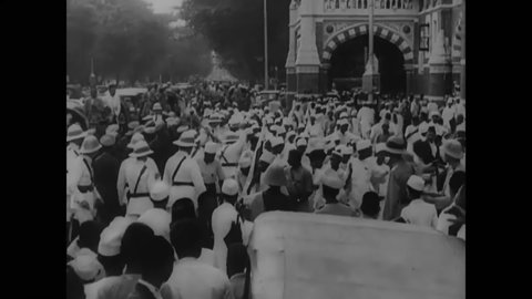CIRCA 1940 - British soldiers surround and control a group of civilians protesting for independence in Delhi, India.