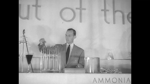 CIRCA 1940s - A DuPont chemist demonstrates the use of different equipment in his lab.