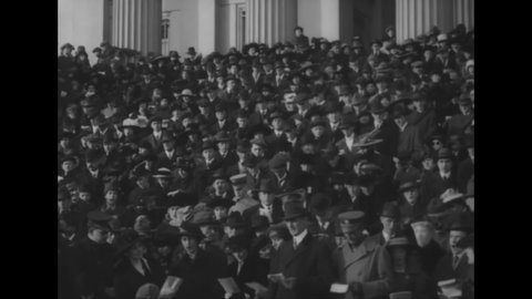 CIRCA 1919 - Secretaries Daniels and McAdoo lead Christmas Carolers in singing on the steps of the Treasury in Washington DC.