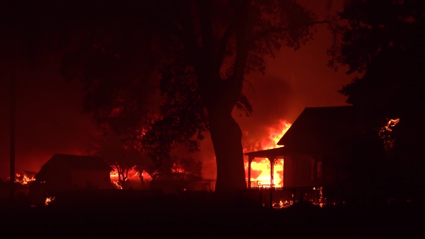 NORTHERN CALIFORNIA - CIRCA 2021 - A house is engulfed in flames at night during the disastrous Dixie Fire in Northern California.