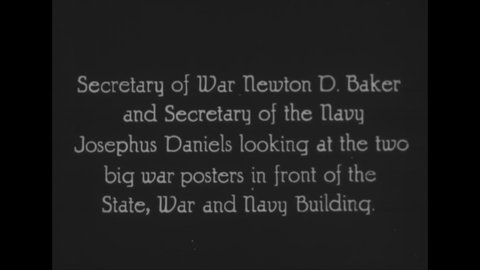 CIRCA 1918 - Secretaries Baker and Daniels admire a propagandistic billboard outside the State, War and Navy Building in Washington DC.