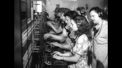 CIRCA 1940s - A woman supervises switchboard operators at an atomic power plant.