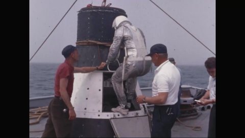 CIRCA 1964 - One of the Mercury Seven astronauts enters a space capsule to test its ability to float off the coast of Pensacola, Florida,