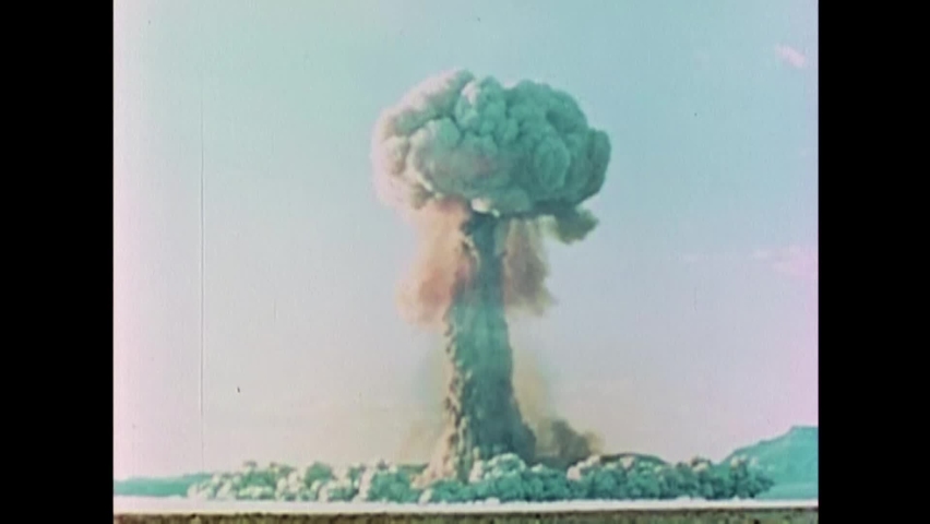 CIRCA 1950s - The mushroom cloud left in the aftermath of an atomic bomb drop in Yucca Flat, Nevada takes up most of the screen.