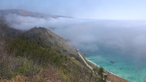 BIG SUR, CALIFORNIA - CIRCA 2021 - High angle of fog rolling into the coast of California near Big Sur.