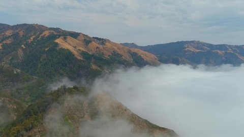 BIG SUR, CALIFORNIA - CIRCA 2021 - Beautiful aerial of fog rolling into the coast of California near Big Sur.